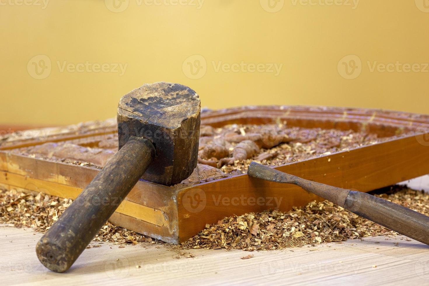 Antique hammers and chisels made of wood are used for carving objects. photo