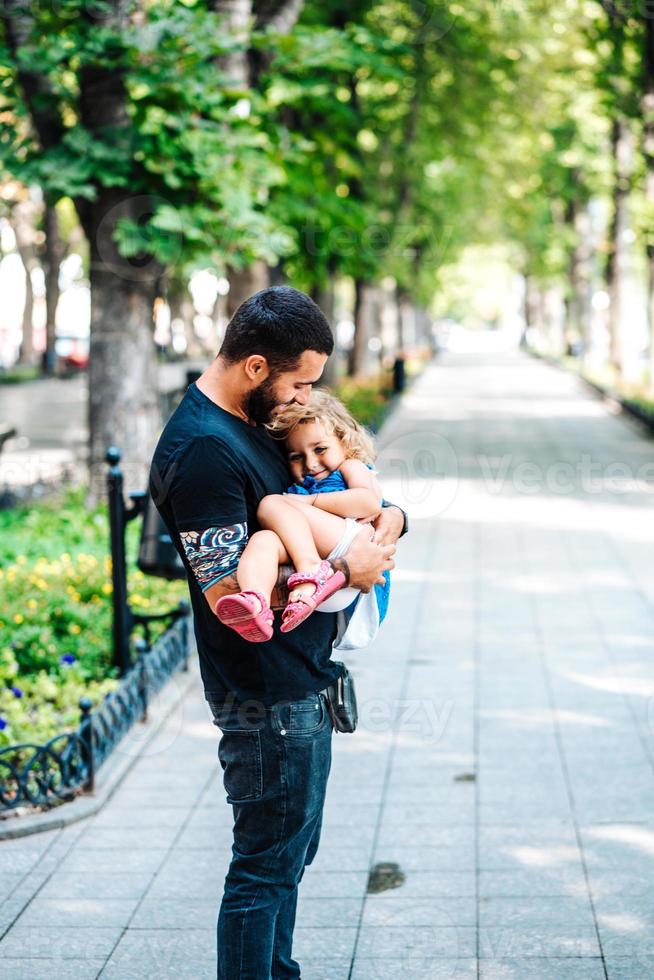 Cute little girl in her father's arm photo