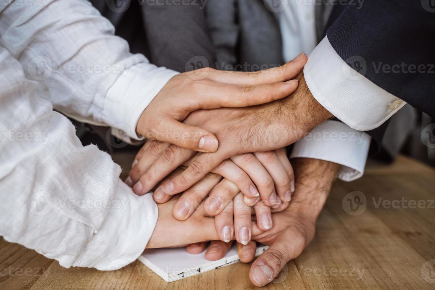 United hands of business team on workspace background photo