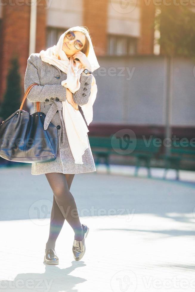 girl in a coat on the street photo