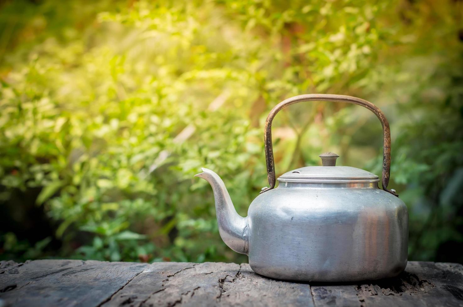 Kettle on wooden table in the morning photo