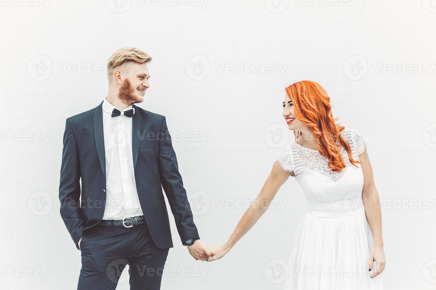 Wedding couple on a background of whitewall photo