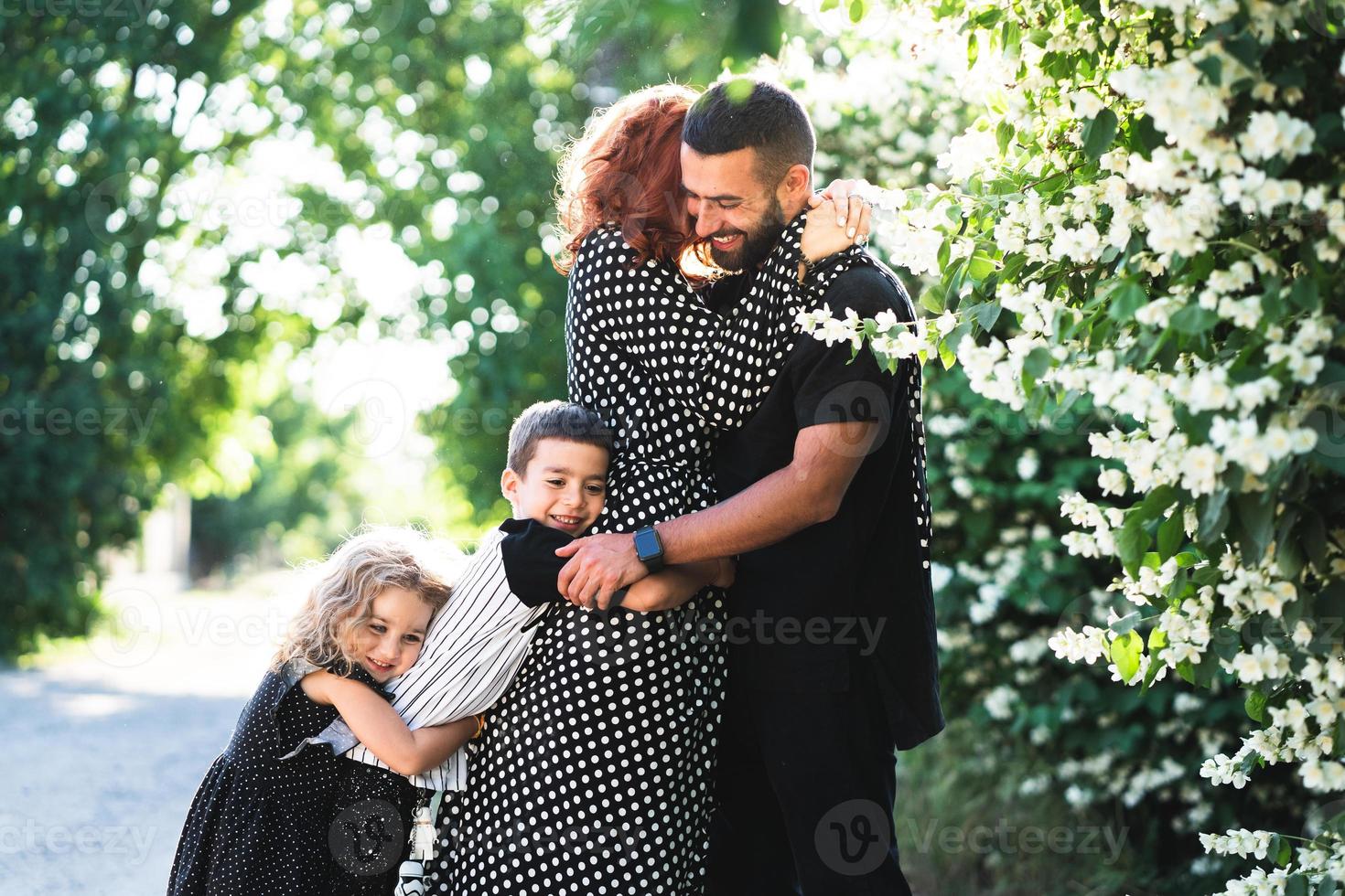 Mom, Dad, little son and daughter have fun photo