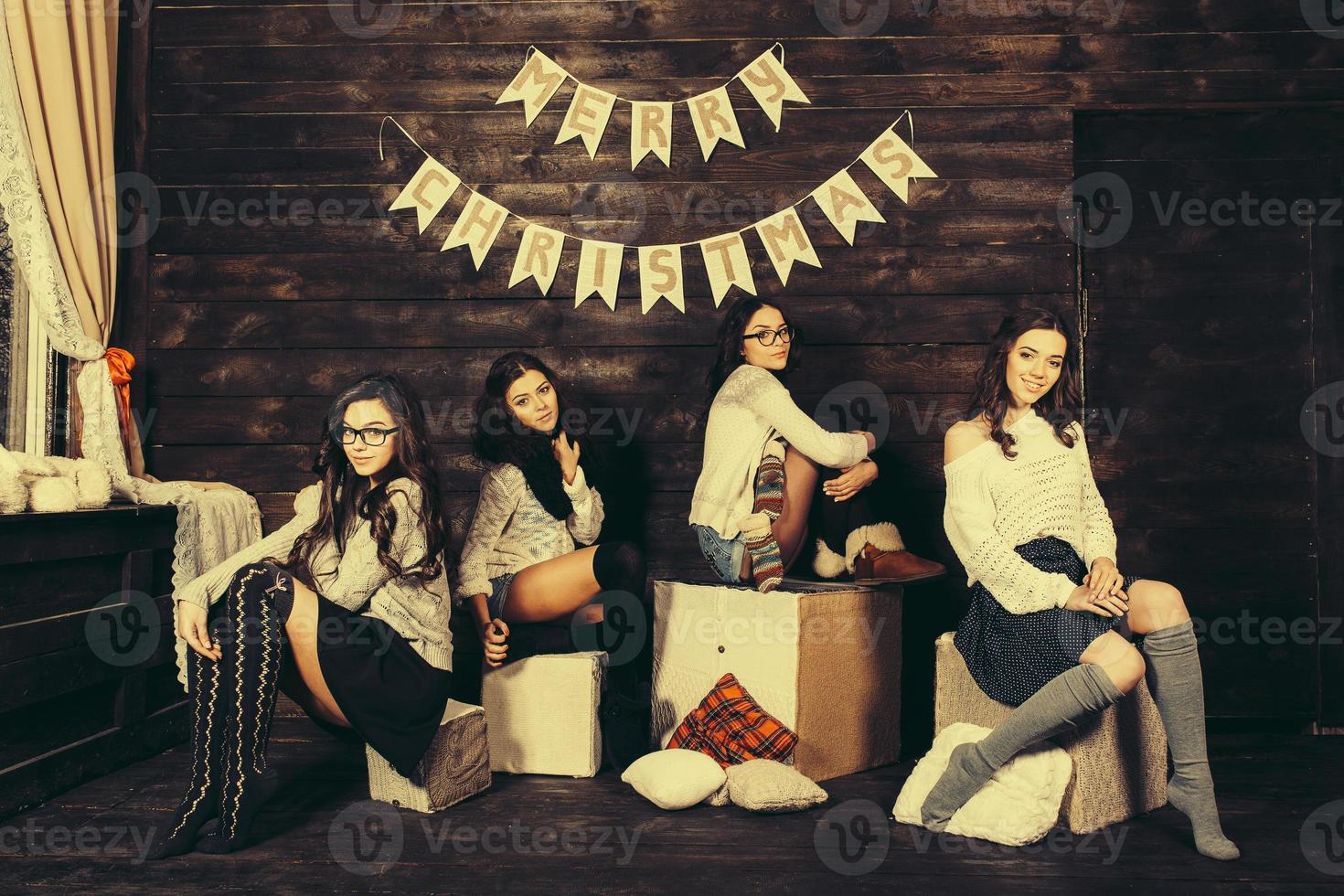 Four charming model posing on a vintage New Year's background photo