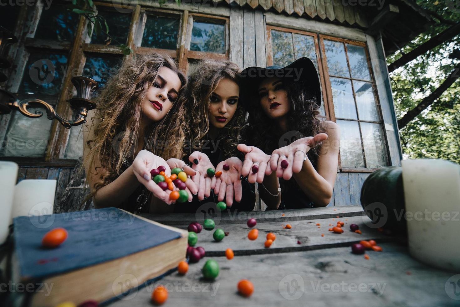 Three vintage witches perform magic ritual photo