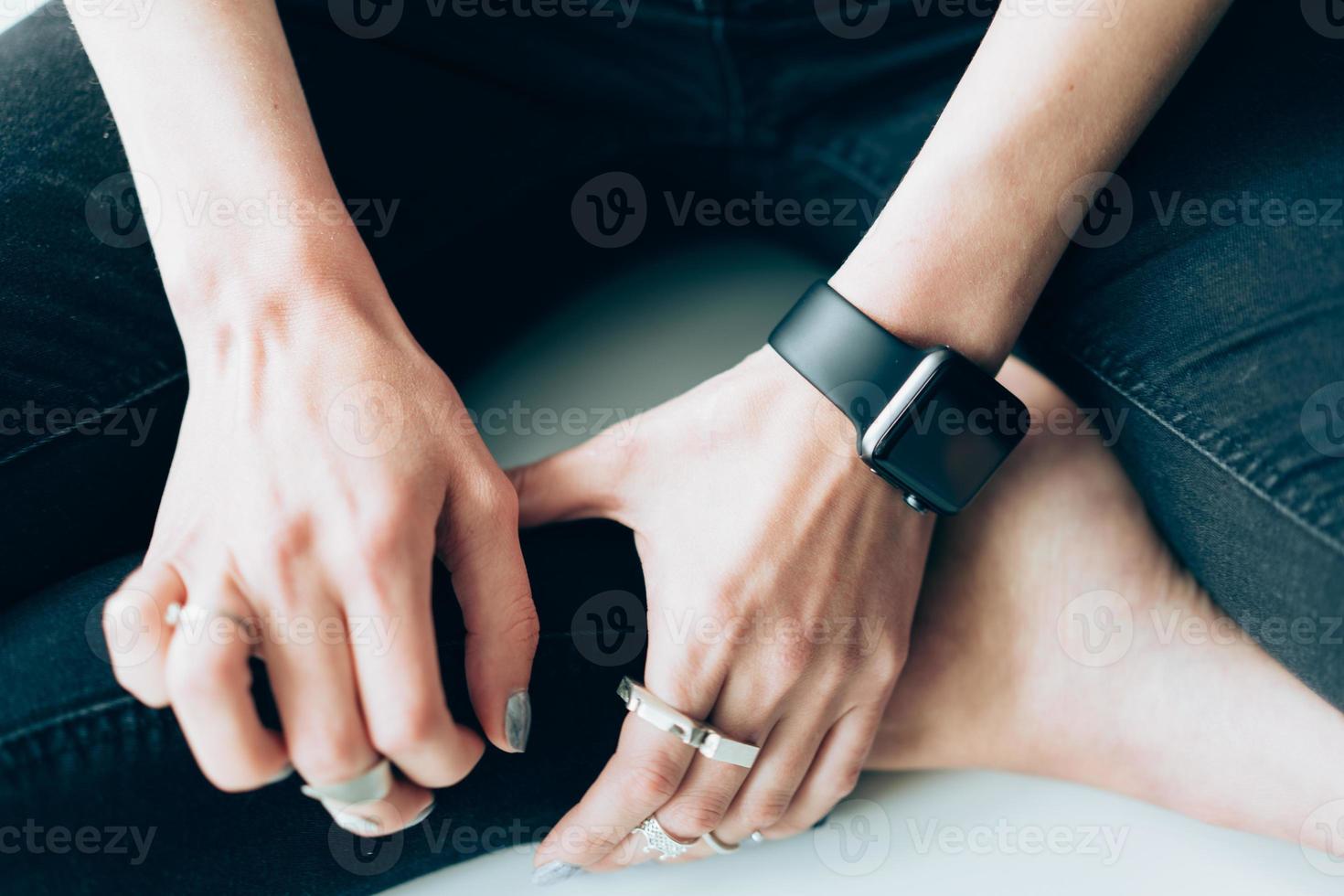 Slender girl with a smart clock on her arm photo