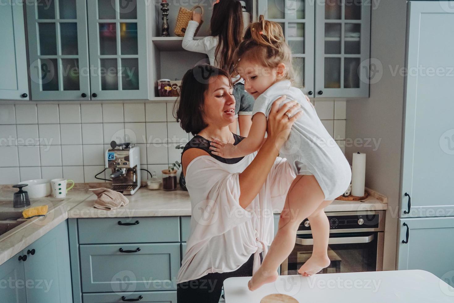 Happy family having fun in the kitchen photo