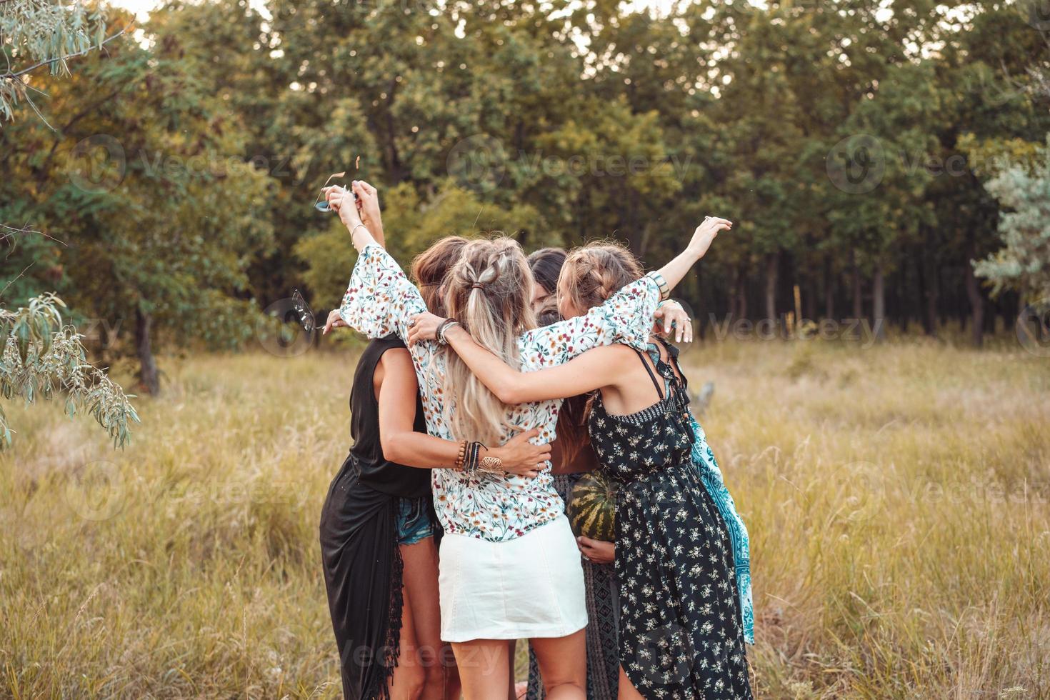 Girls stand in a circle embracing each other photo