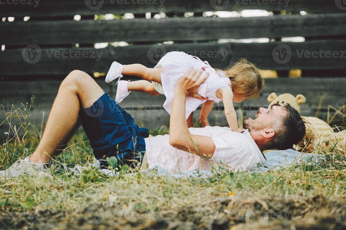 Happy family on lawn in the park photo