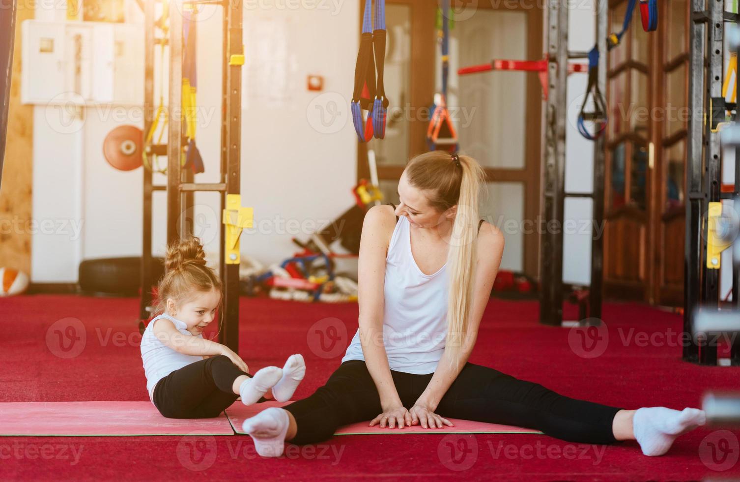 Mom and daughter together perform different exercises photo