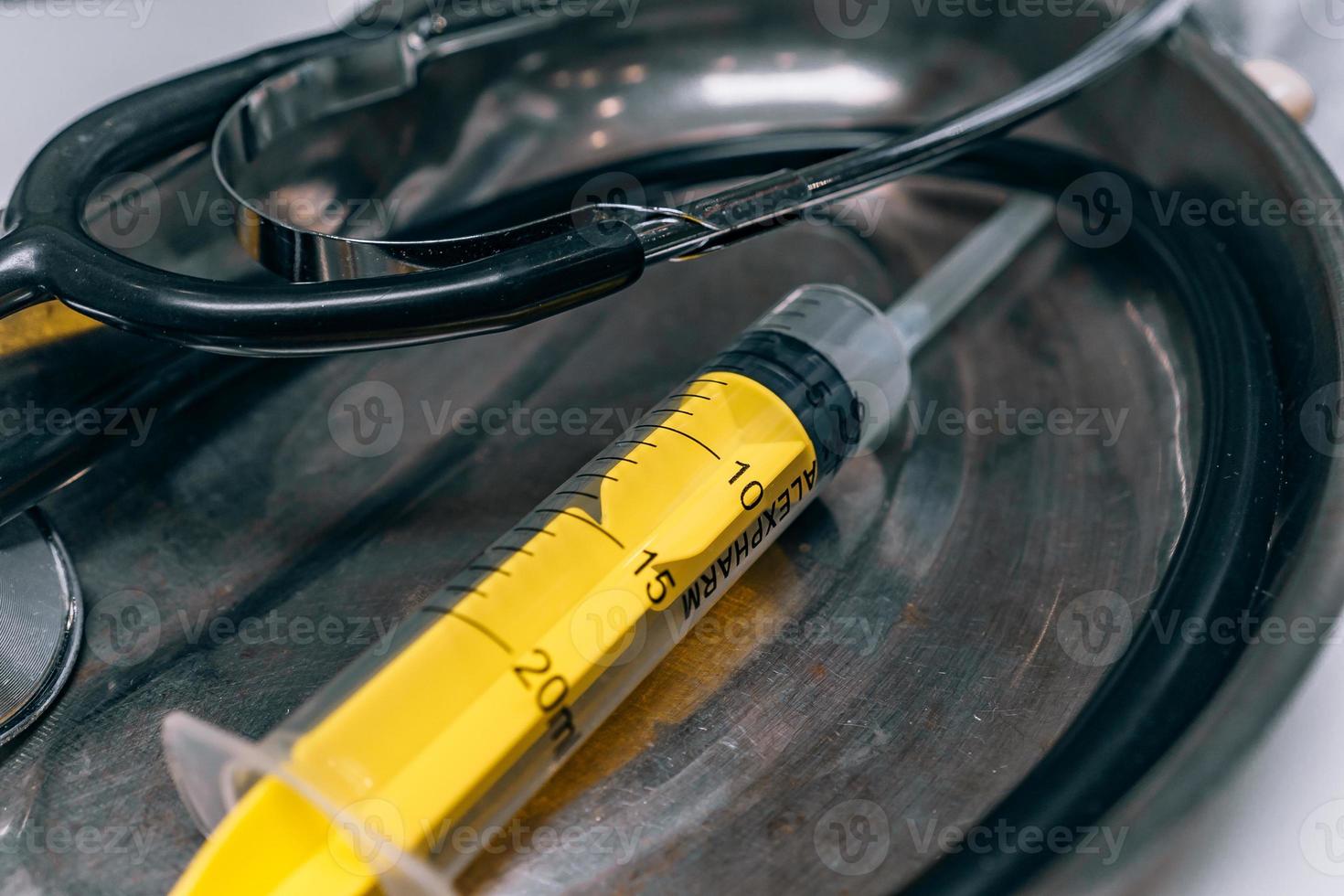 On the surgical tray is a syringe and a phonendoscope photo