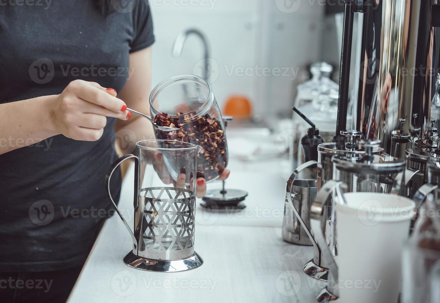 Pour dry tea leaves into the glass container of the tea press maker photo
