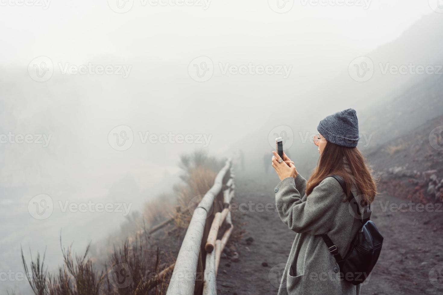 Girl climbs the path to the mountain photo