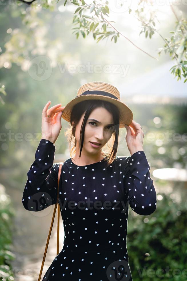 Girl in hat posing on camera photo