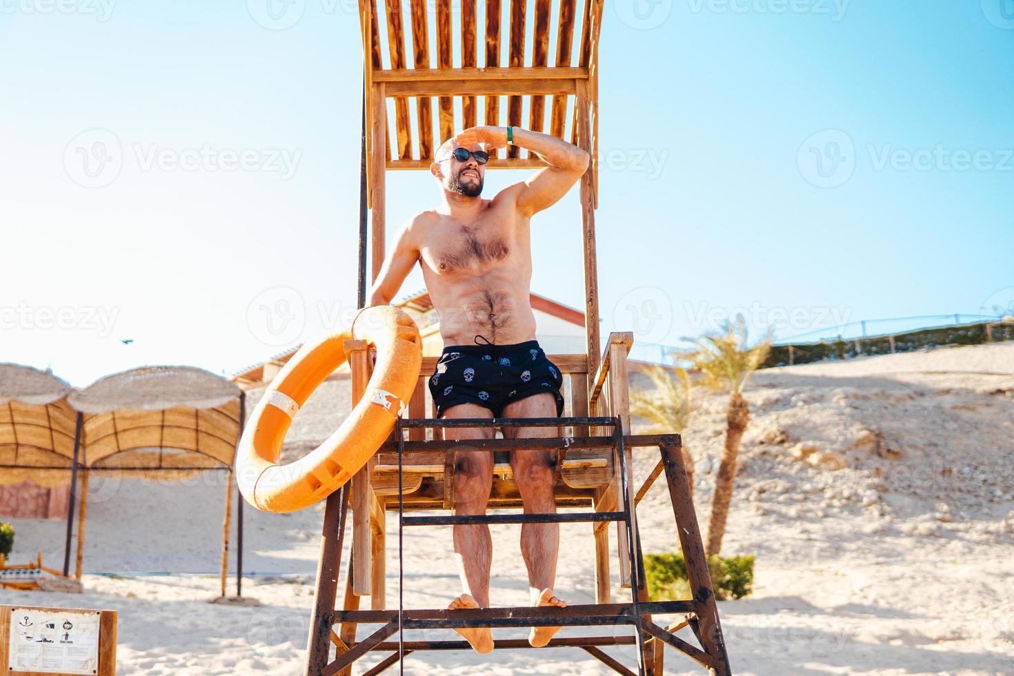 Lifeguard on top of watch tower photo