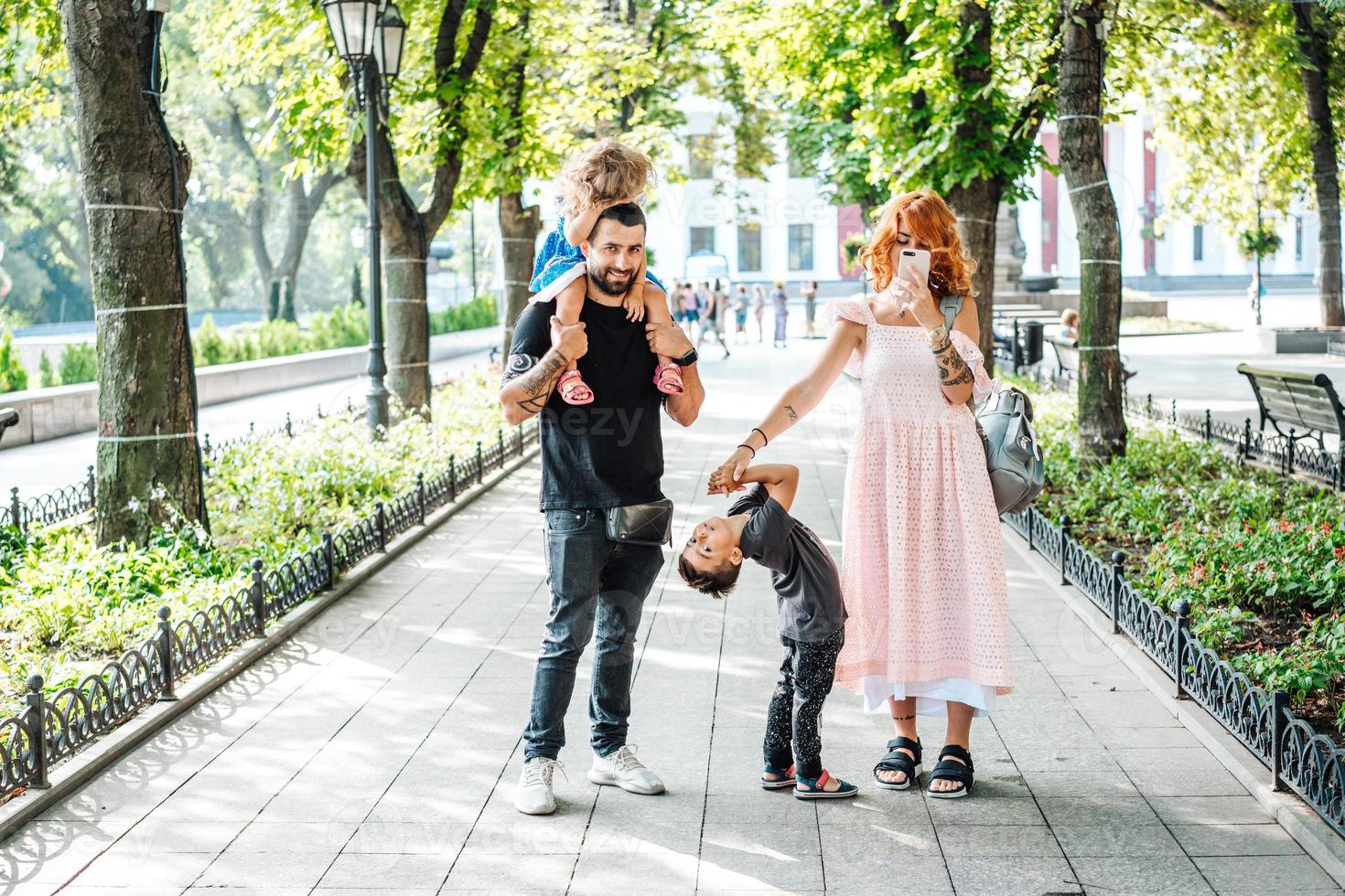 Happy beautiful family walking in the park photo