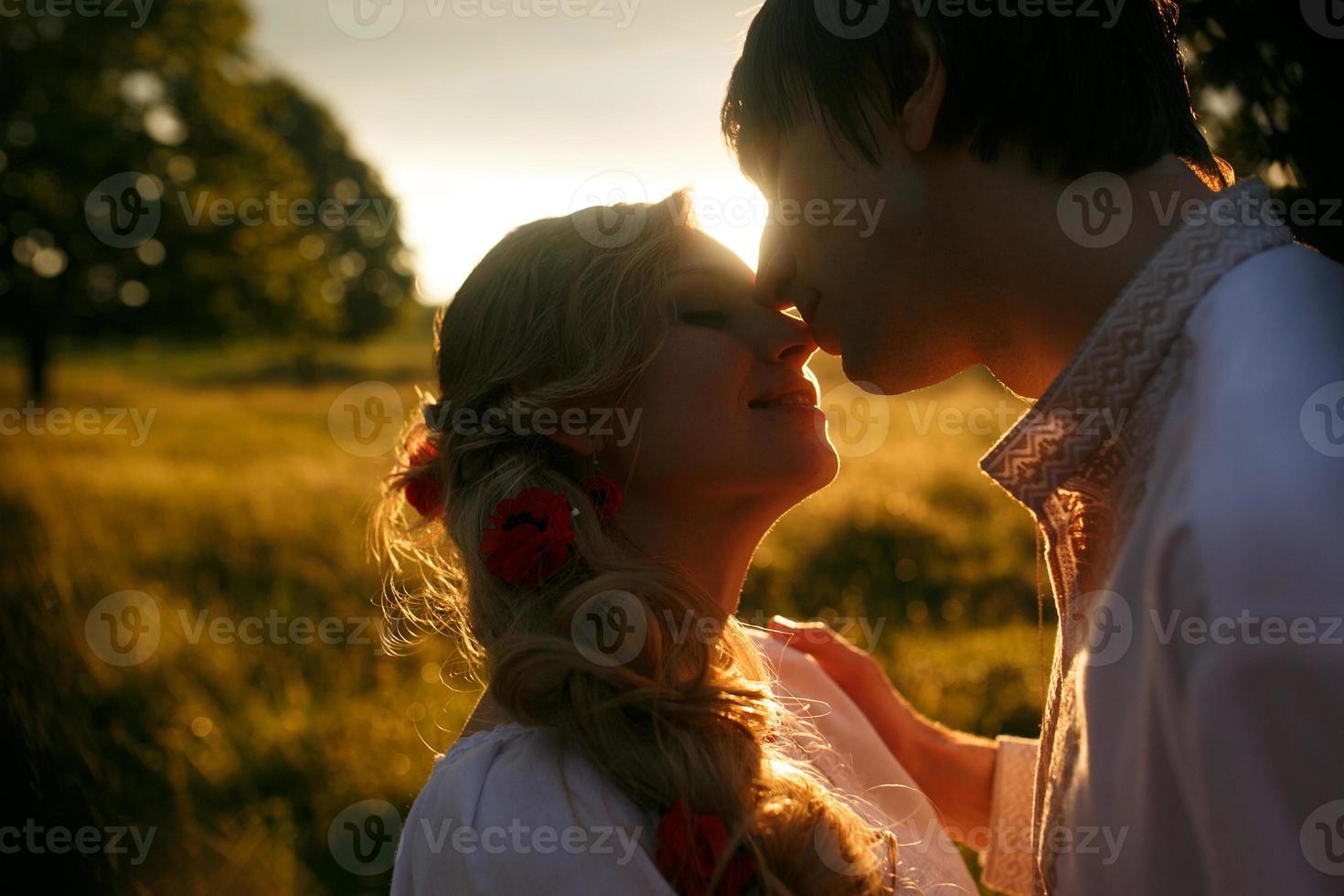 Couple kissing on the sunset photo