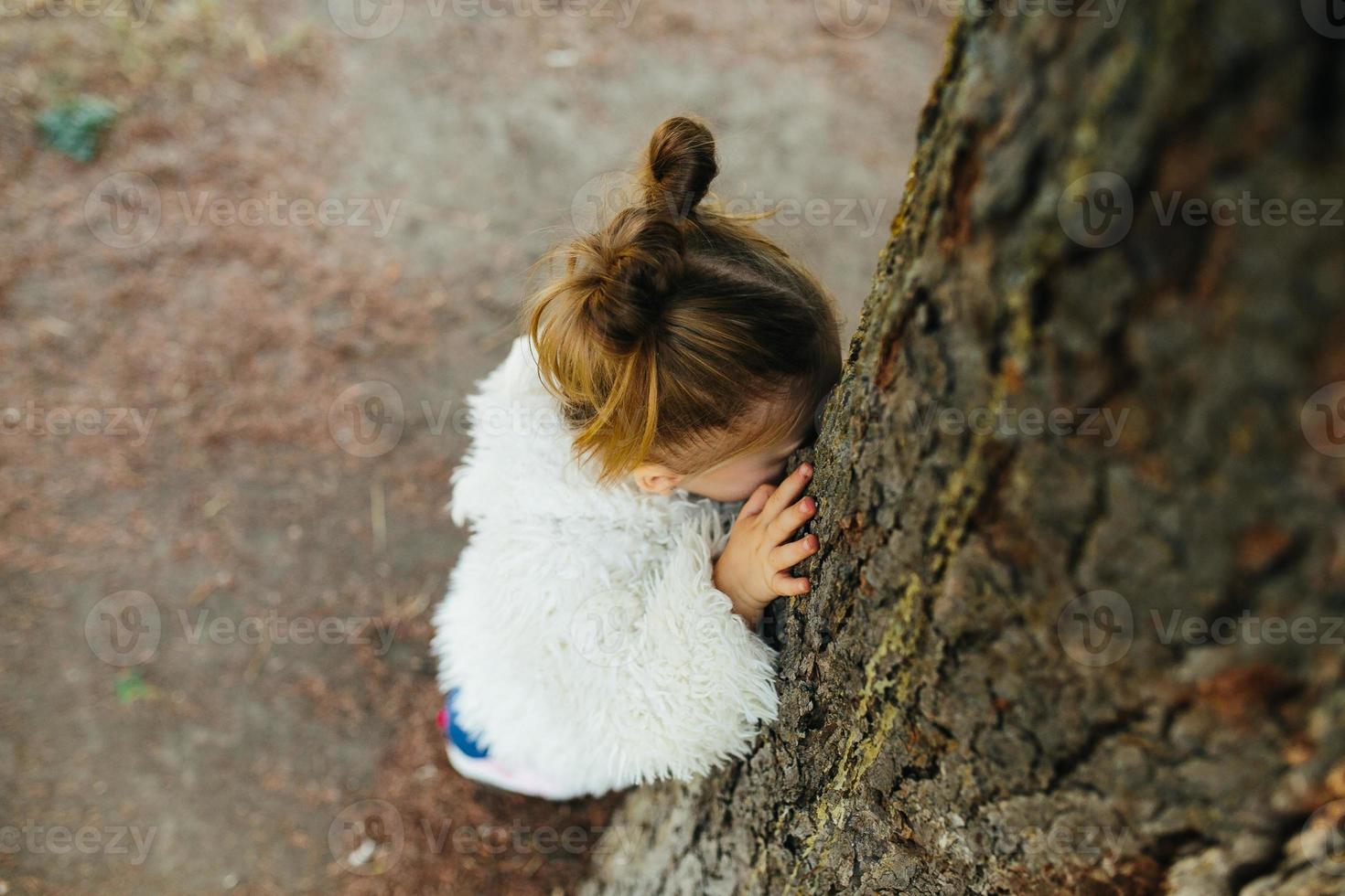 Cute little girl is playing outdoors photo