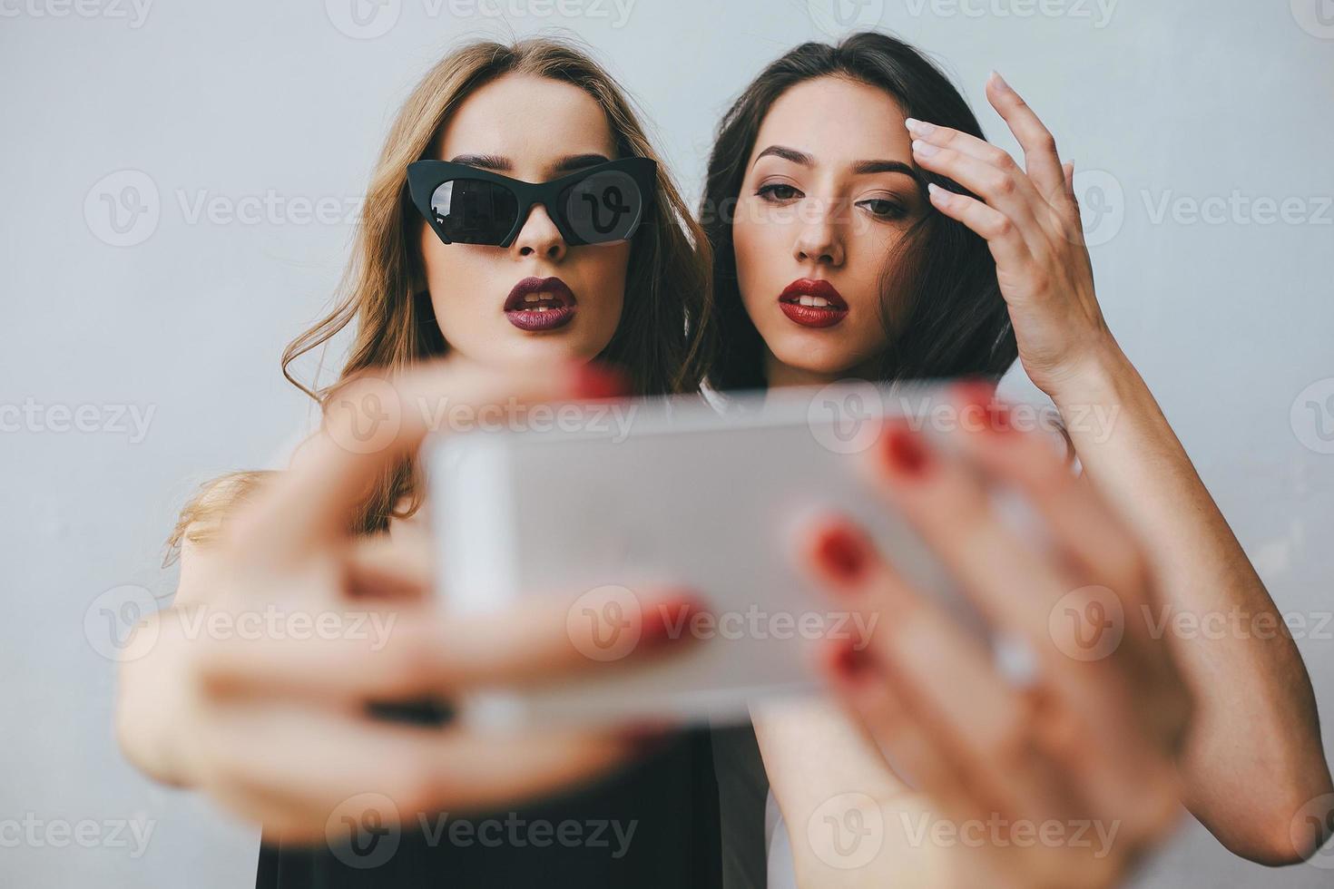 Two girlfriends taking a selfie photo