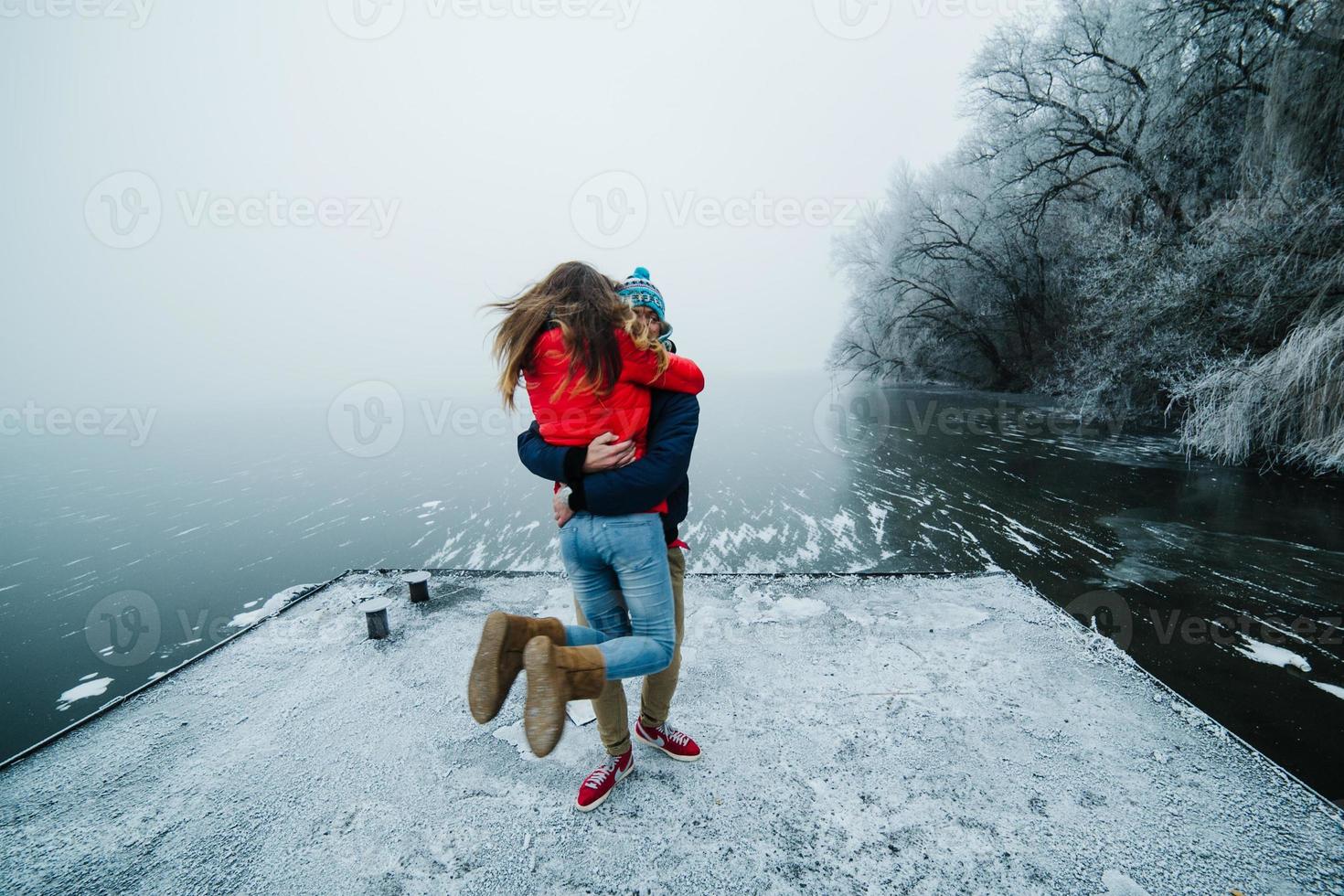 beautiful couple having fun on the pier photo