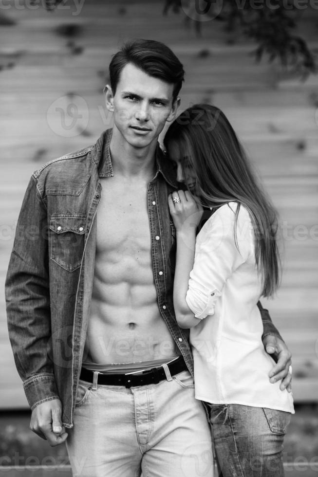 couple posing on a background of the wooden wall photo