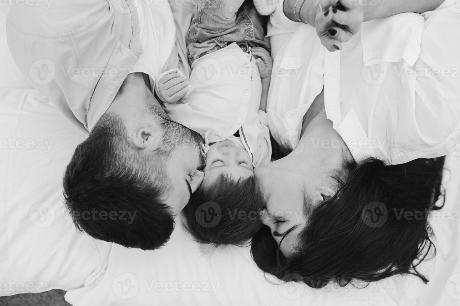 Happy family relaxing together on the mattress photo