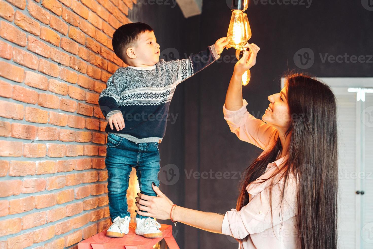 Mother and little son play at home photo