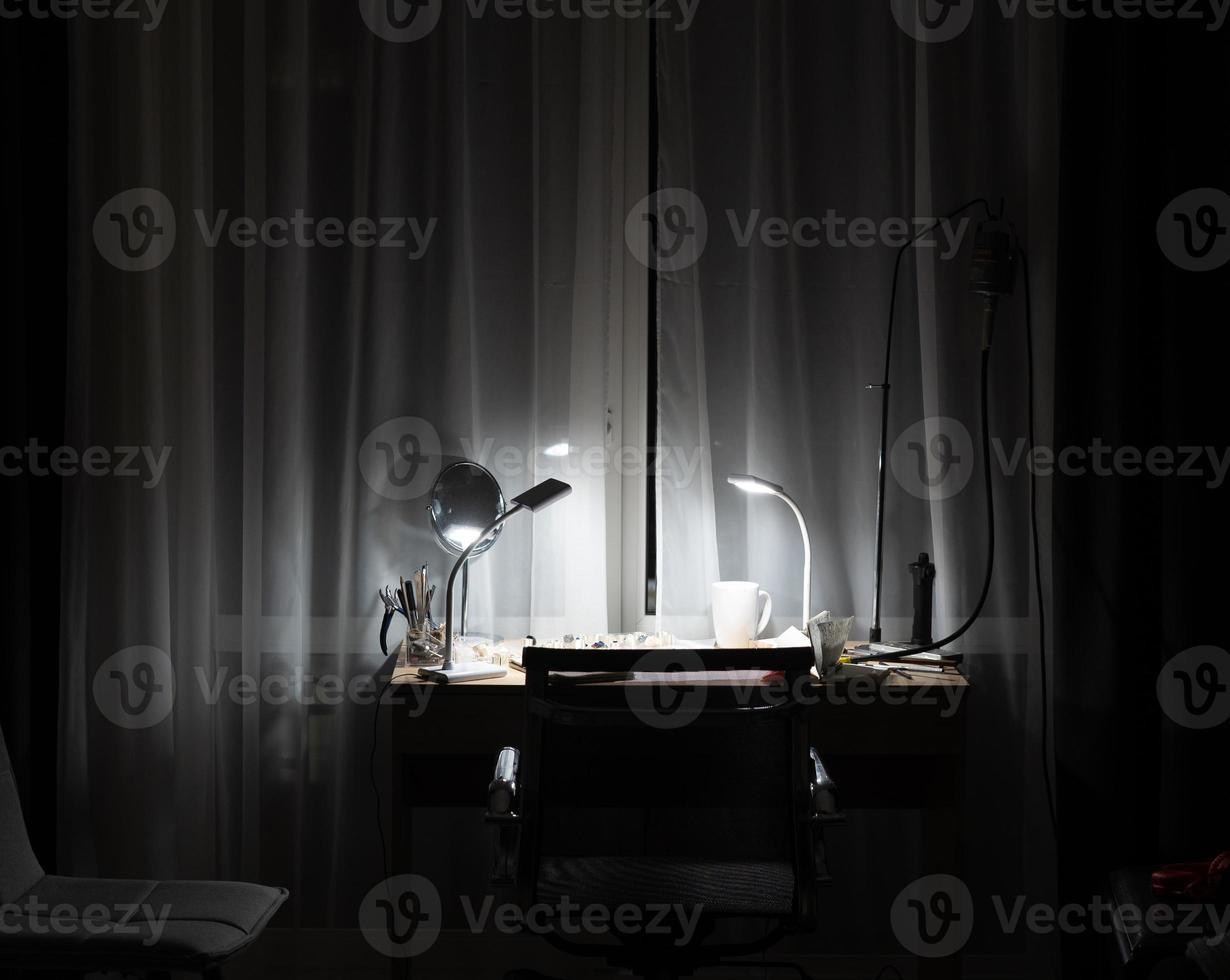 workplace in the room with the lamp on photo