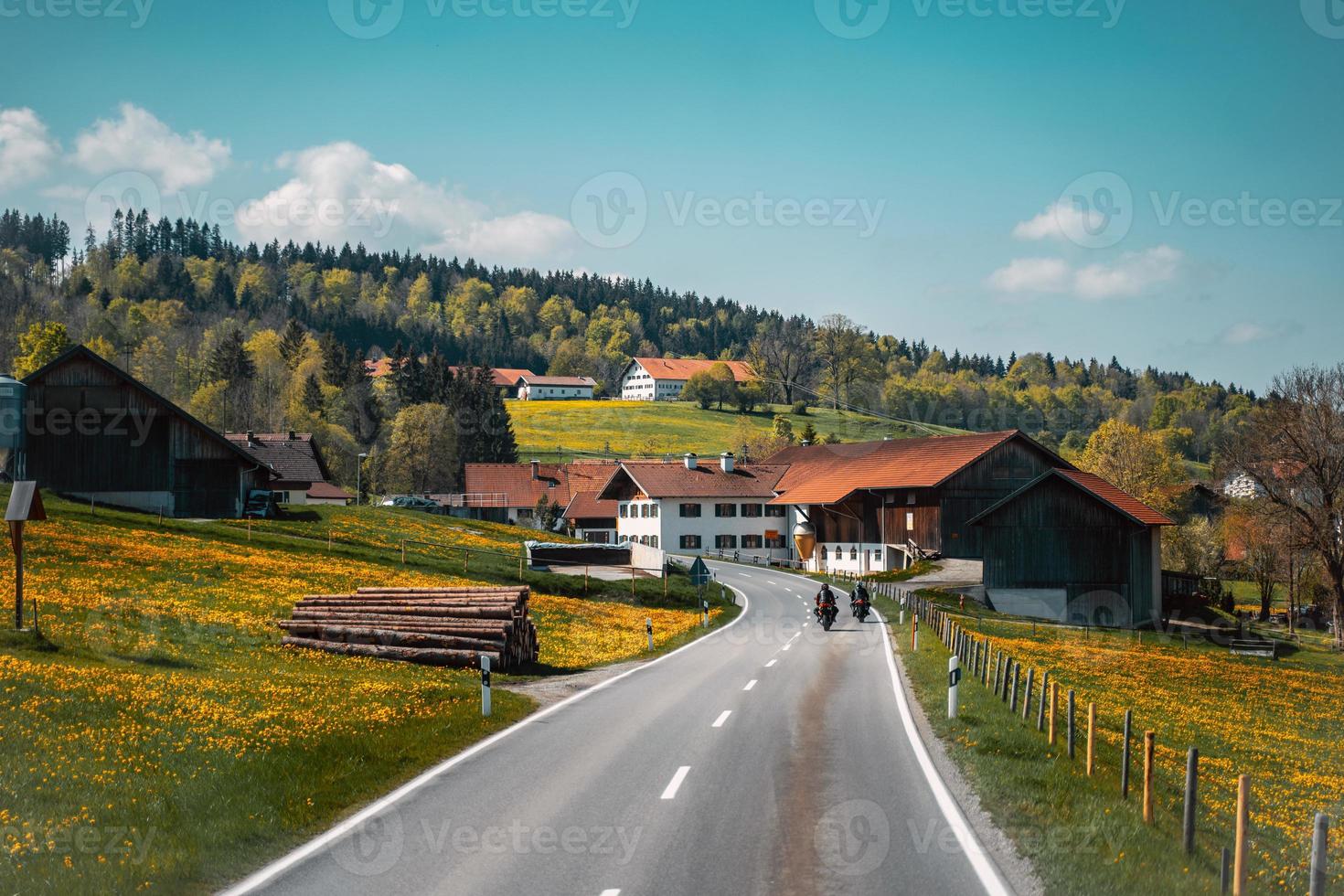 Two biker riding alone on mountainous road photo