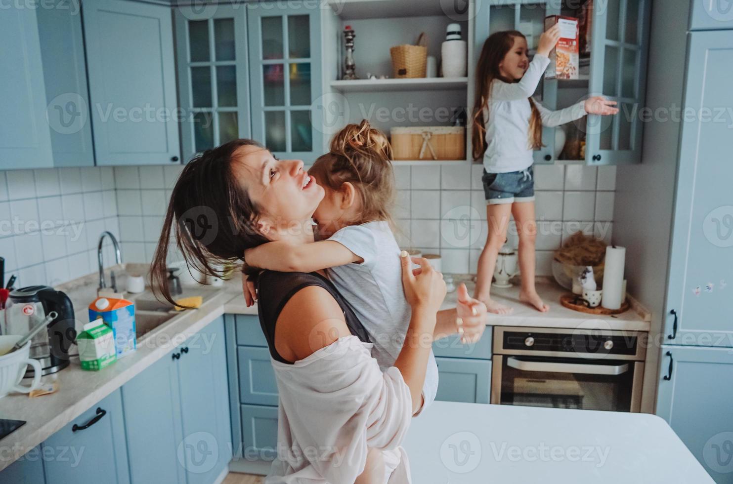 Happy family having fun in the kitchen photo