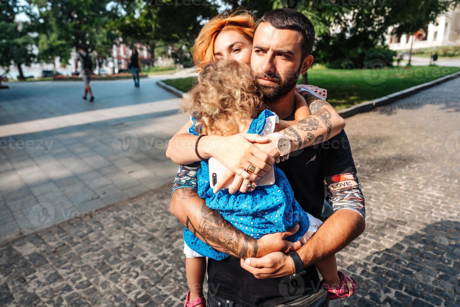 Young couple with little girl on hands photo