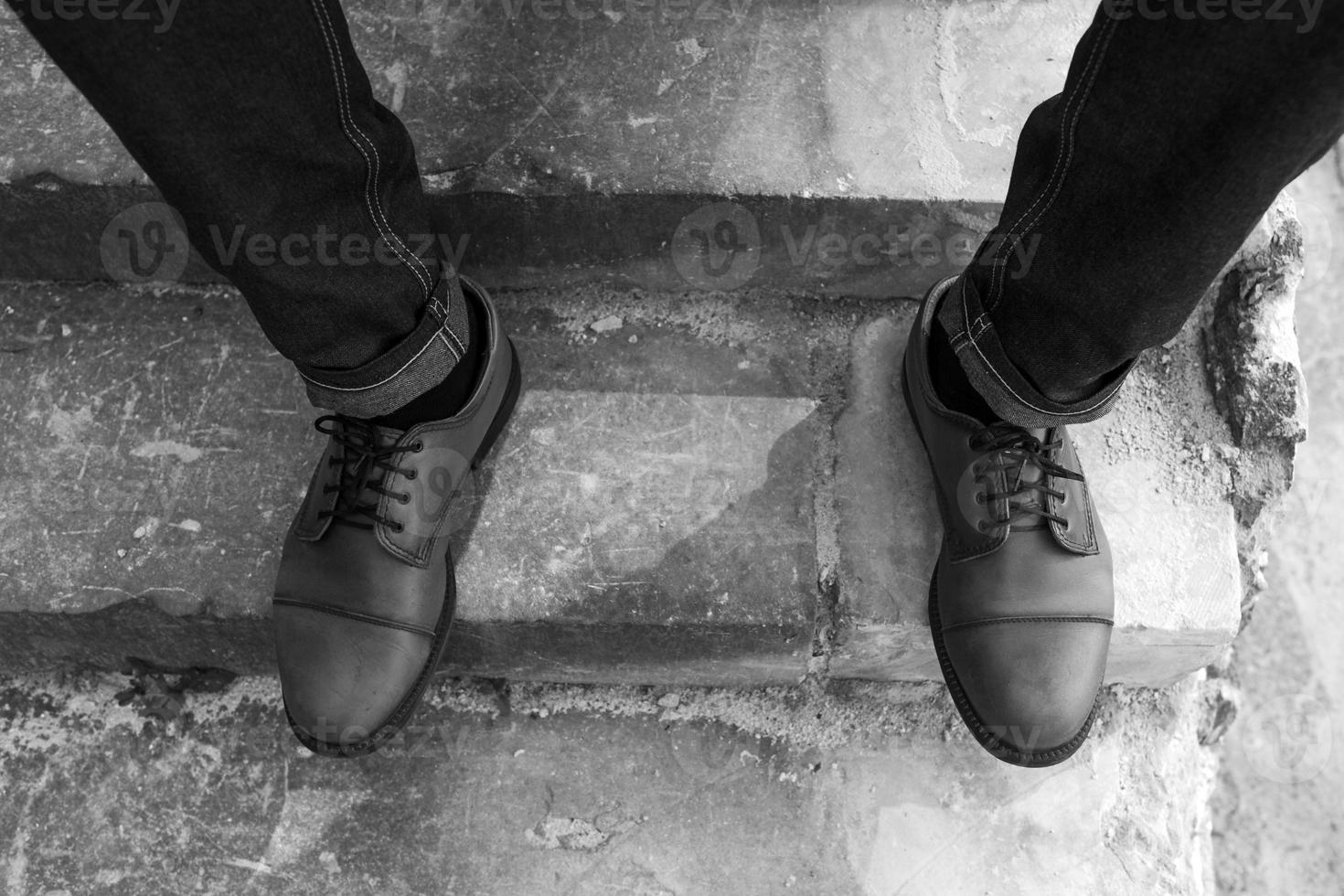 Feet of Men  in selvedge jeans and retro shoes photo