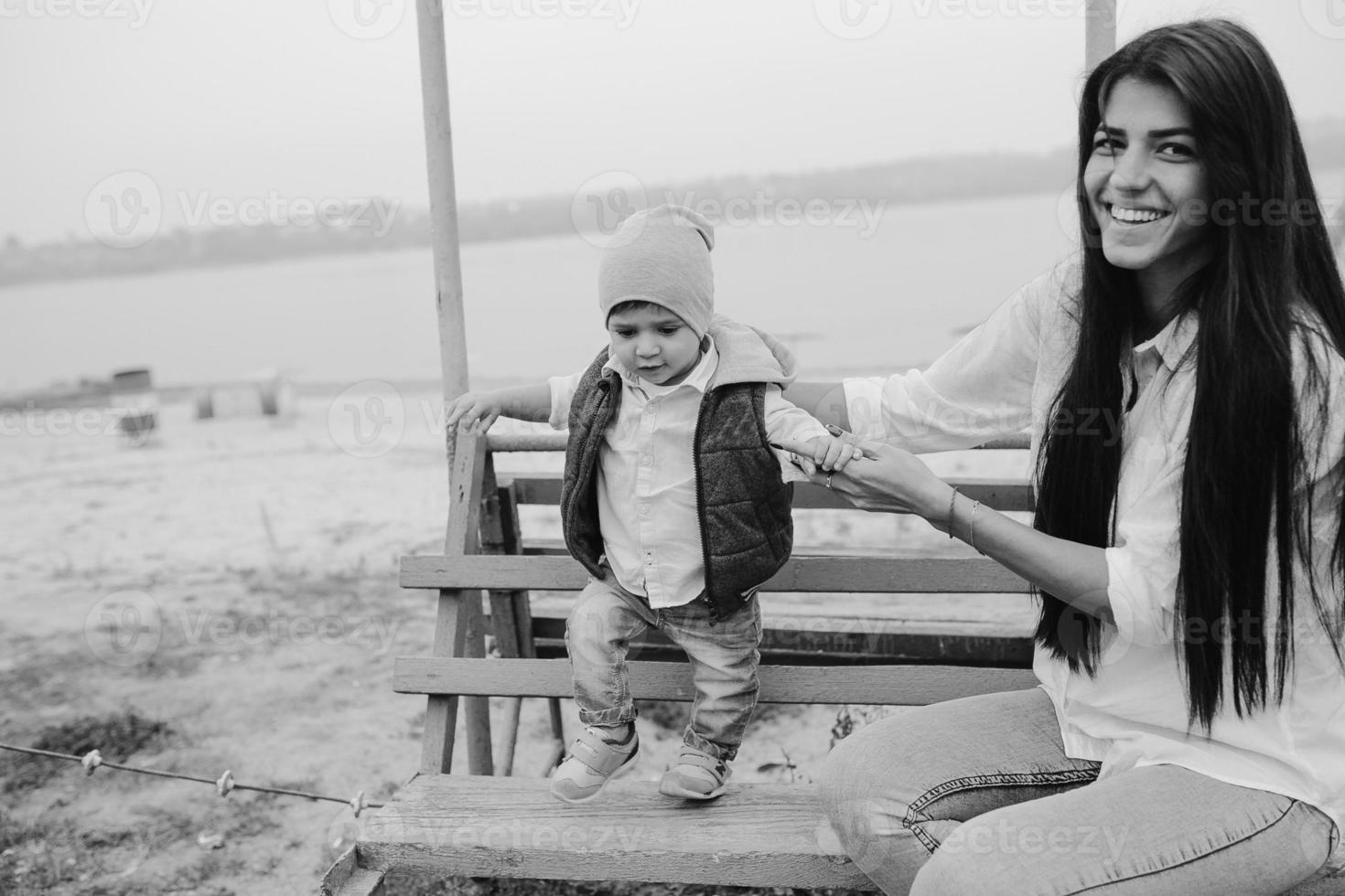 Mother and young son together on a bench photo