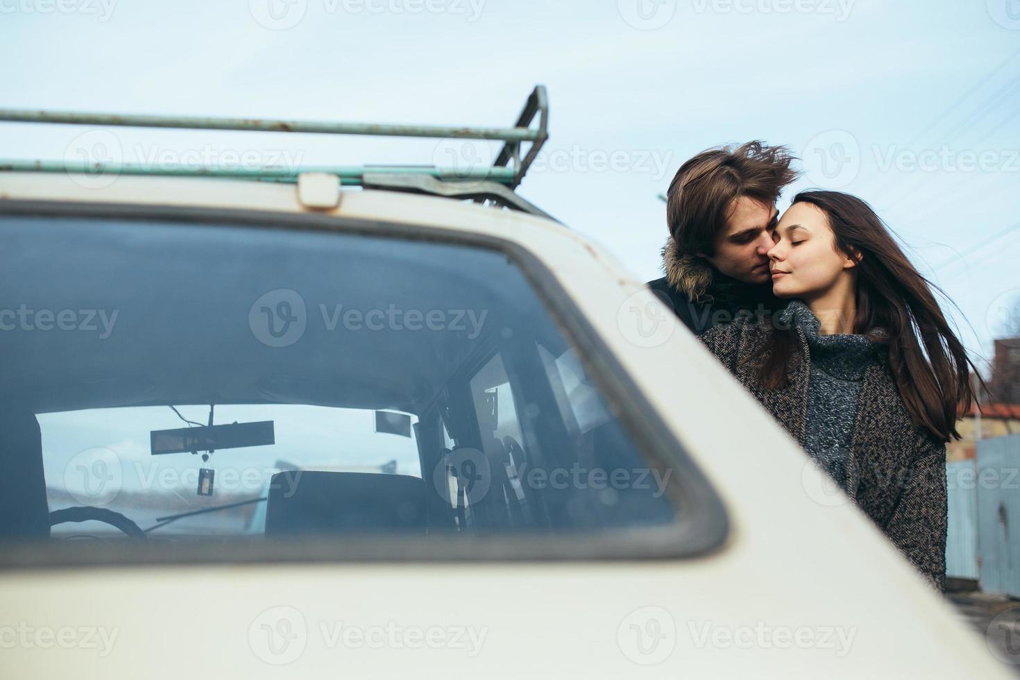 young beautiful couple on the ice of a frozen lake photo