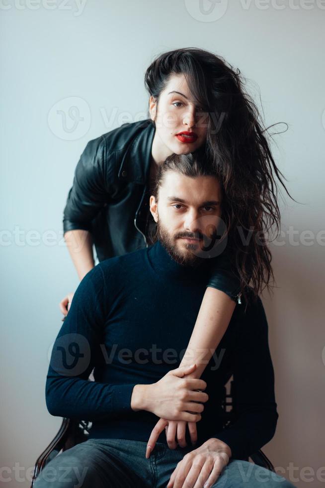 Guy sitting on a chair, girl standing behind him photo