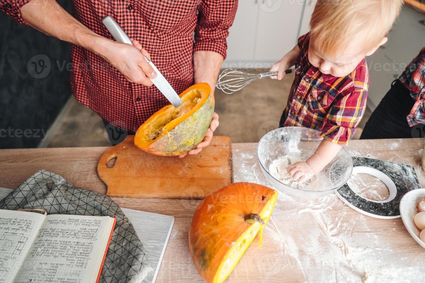 Dad cuts a pumpkin for a pie photo