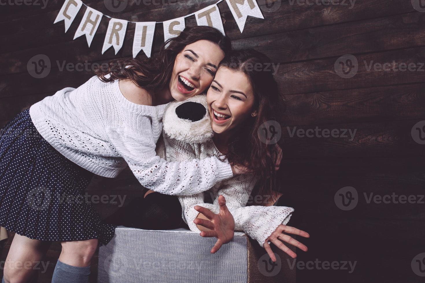 Family New Year's photos, one sister hugging each photo