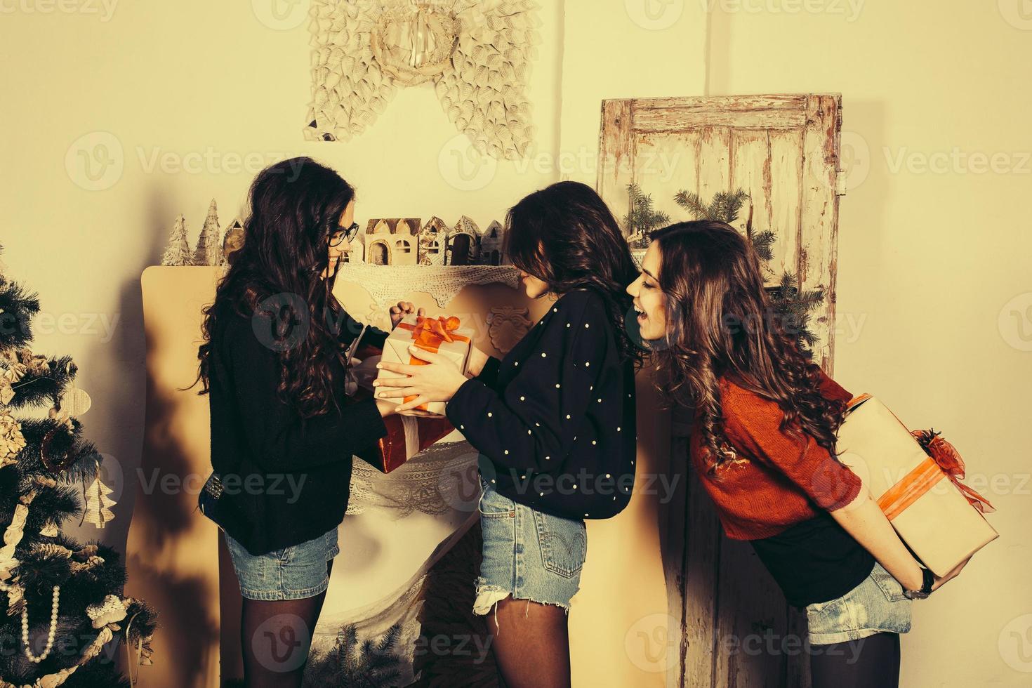 Beautiful girl exchange gifts for the new year. Decorative vintage apartment. photo