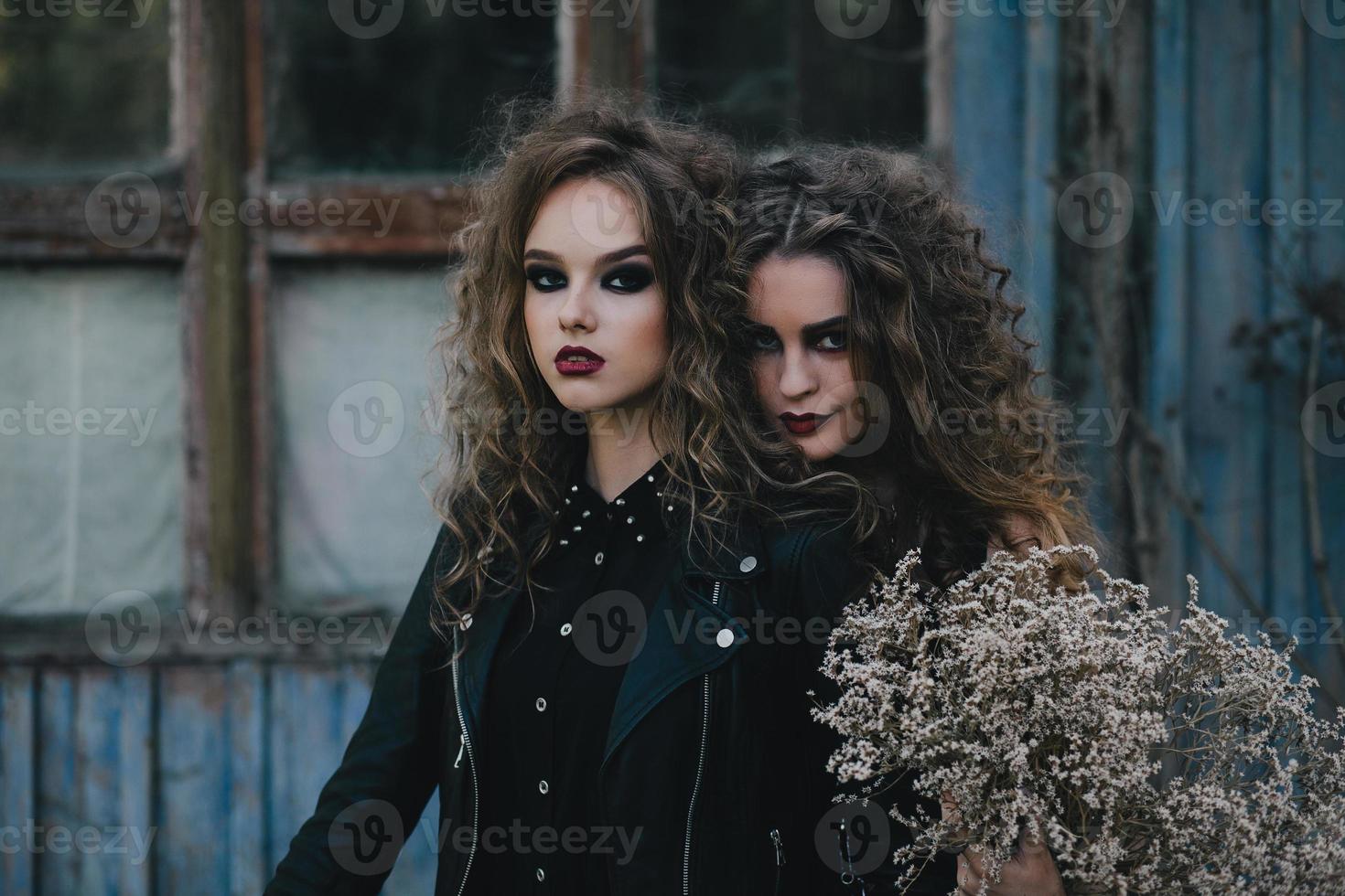 Two vintage witches gathered eve of Halloween photo