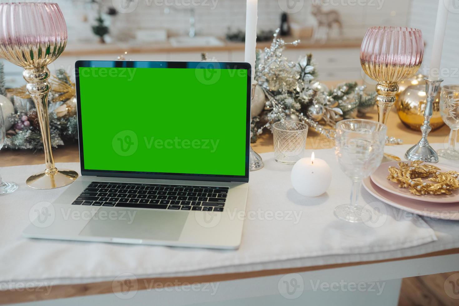 laptop with green screen - chromakey near New Year's decorations. christmas theme. photo