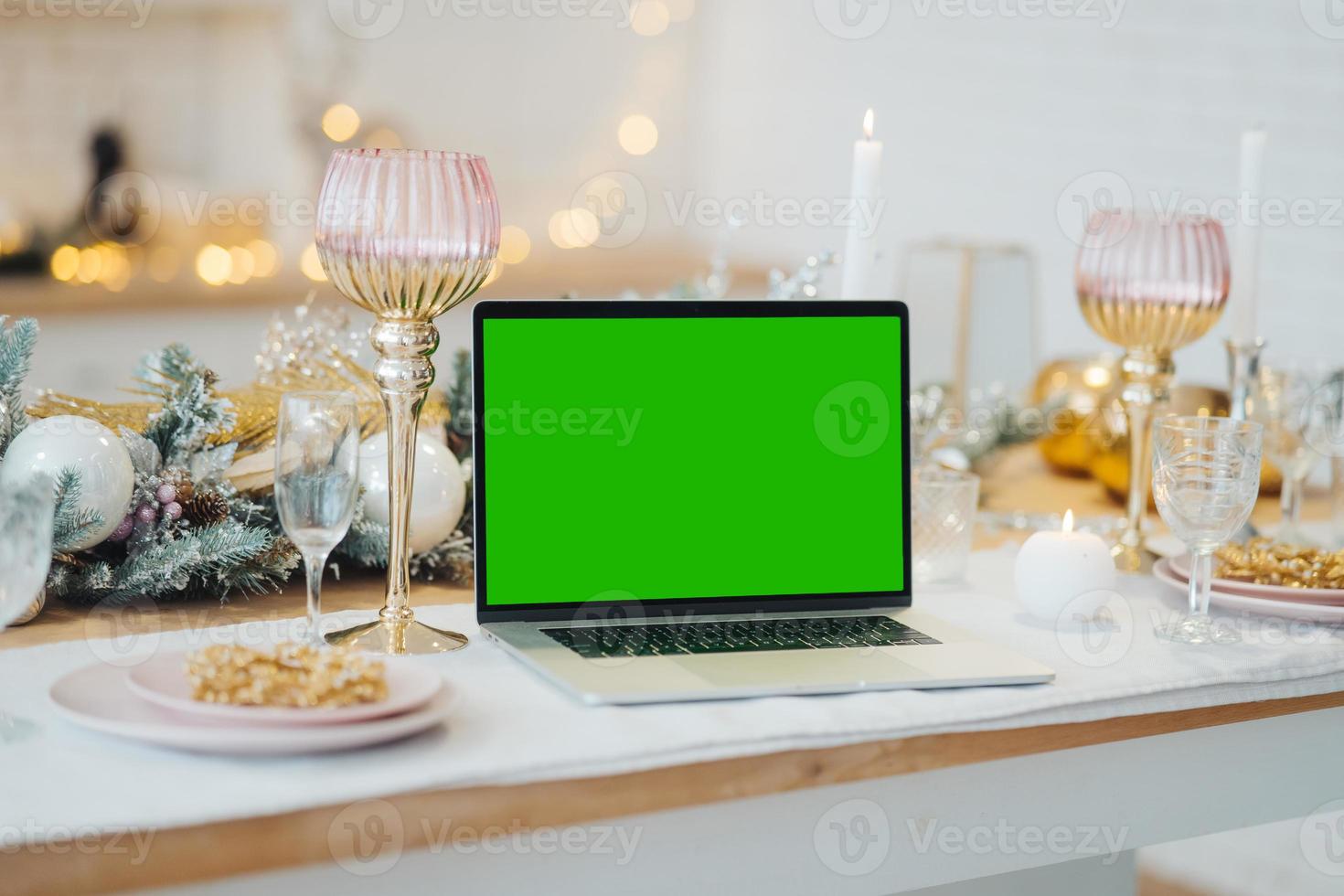 laptop with green screen - chromakey near New Year's decorations. christmas theme. photo