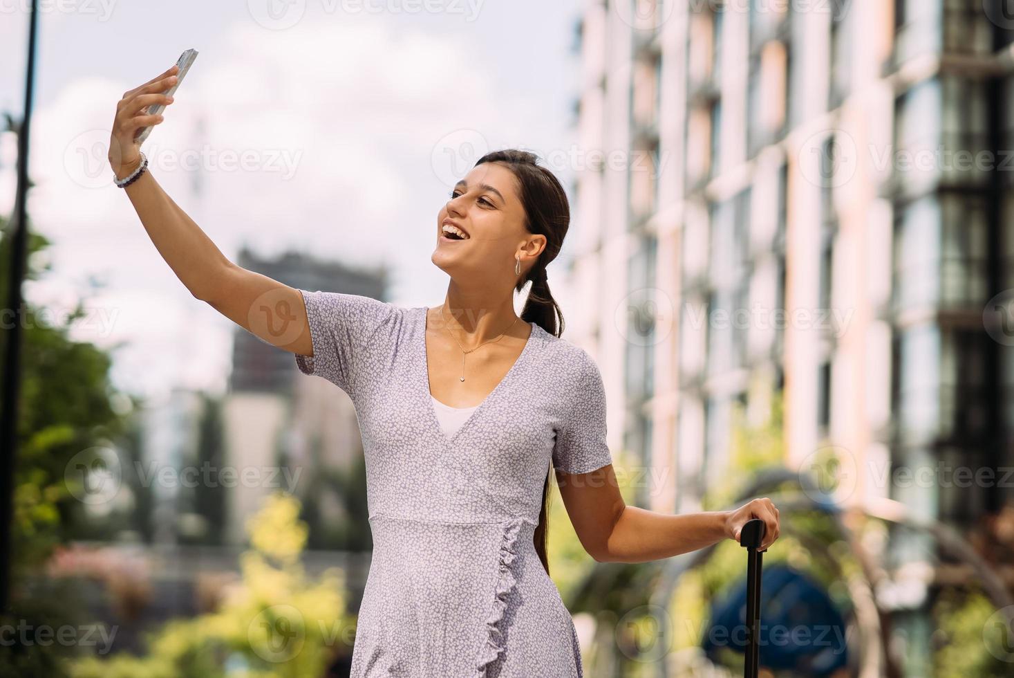 Young woman taking selfies on a phone. photo