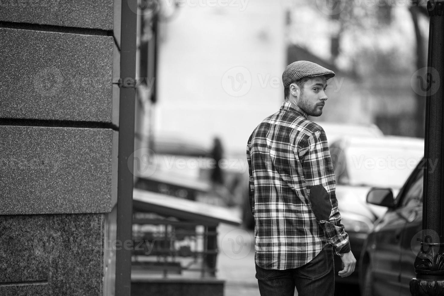 The man in the authentic boots and selvedge jeans  on a background of old city photo