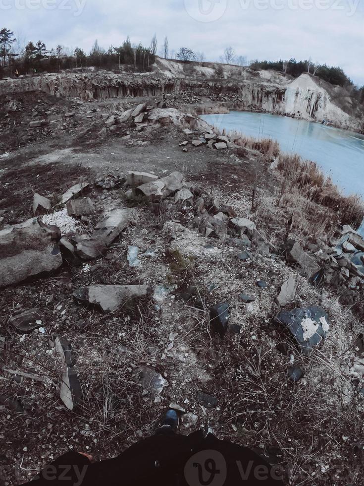 Beautiful quarry, the lake is covered with ice photo