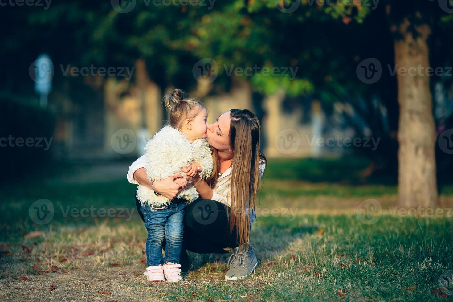 Mother and little daughter in a park photo