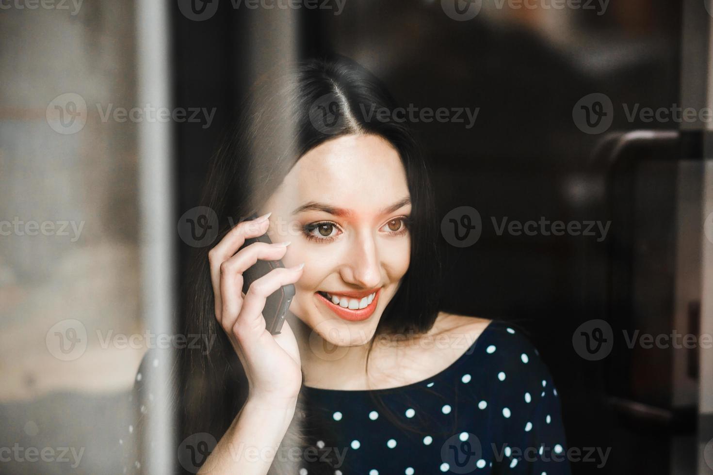 Beautiful girl talking on the phone and smiling photo