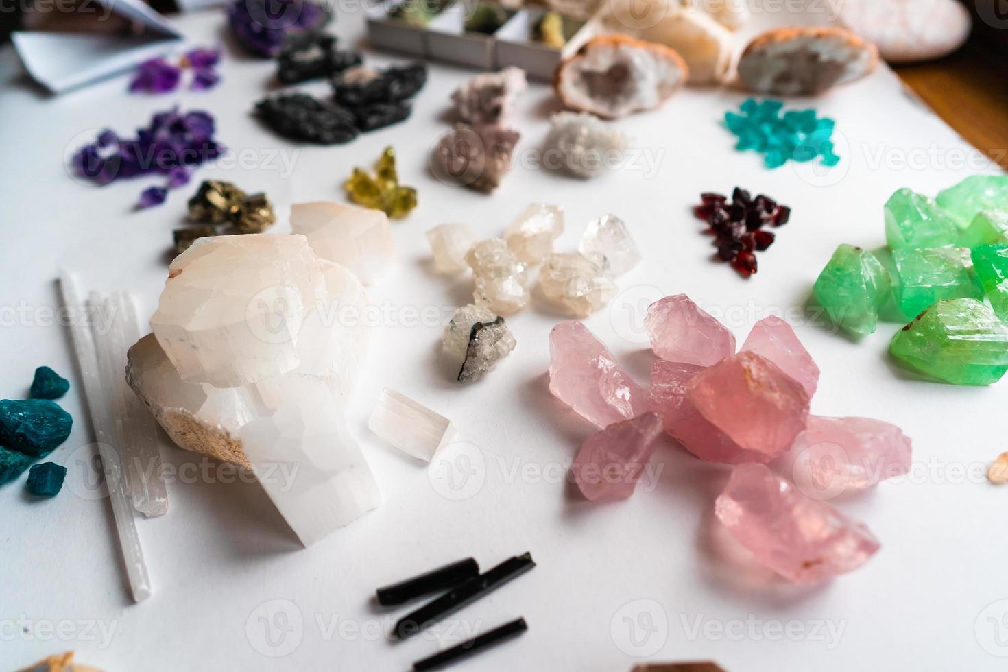 Collection of beautiful precious stones on white table. photo