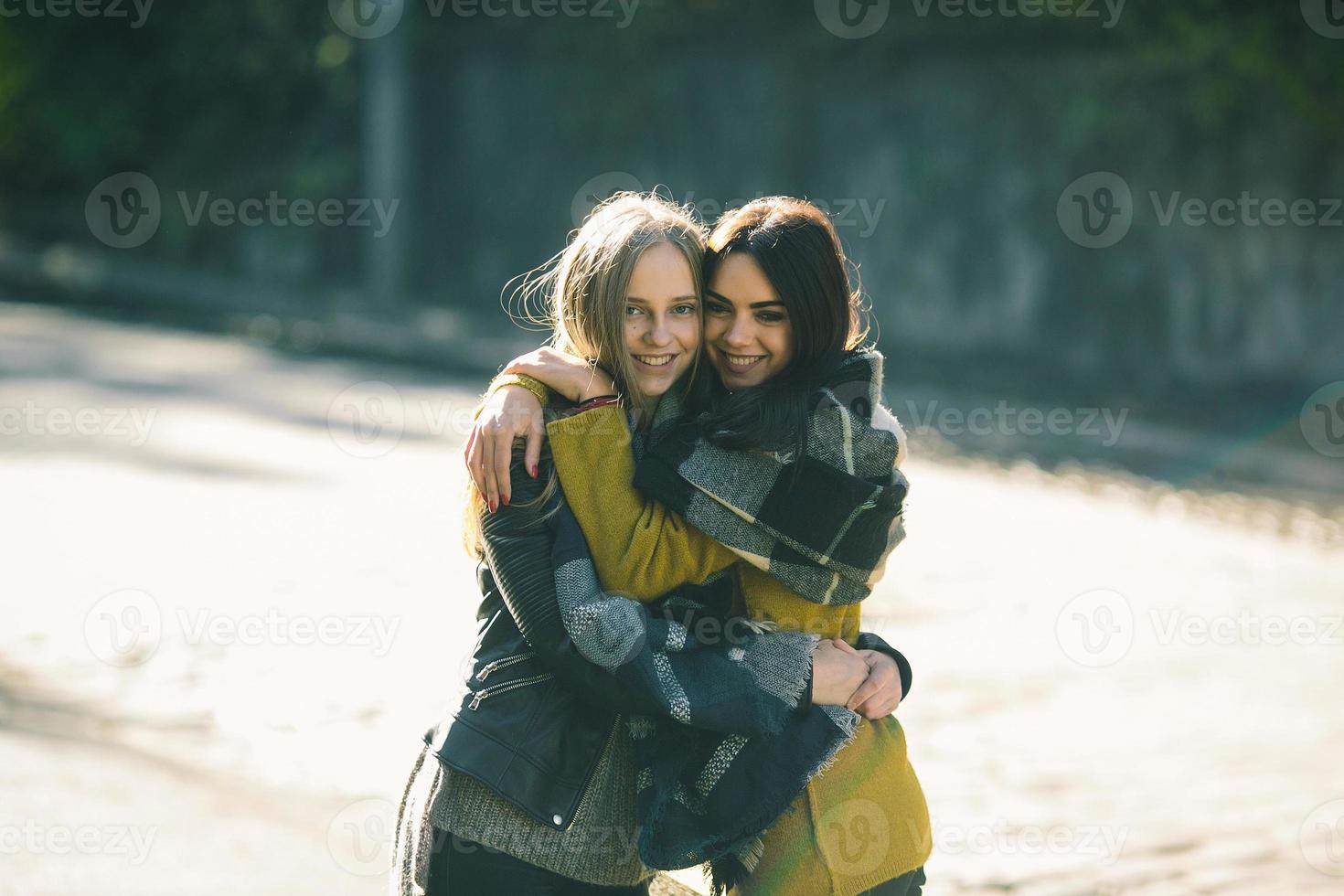 Fashion girls posing on the street photo