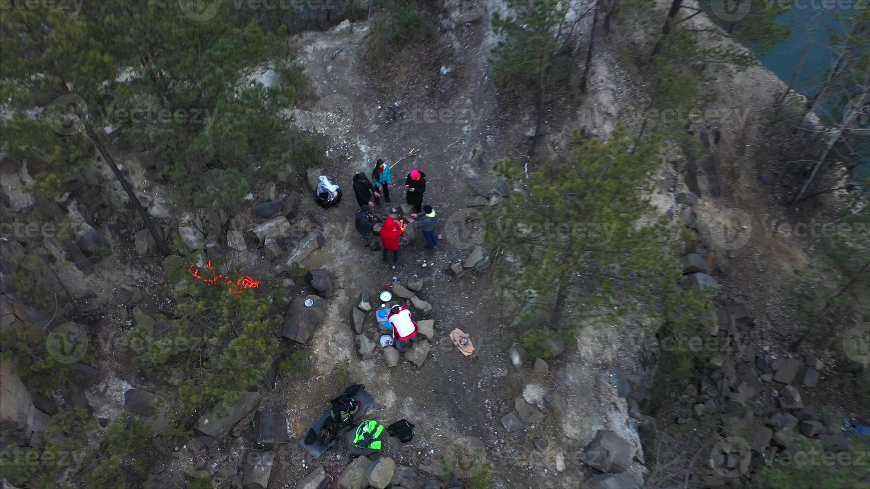 The people warming hands near a bonfire. view from above photo