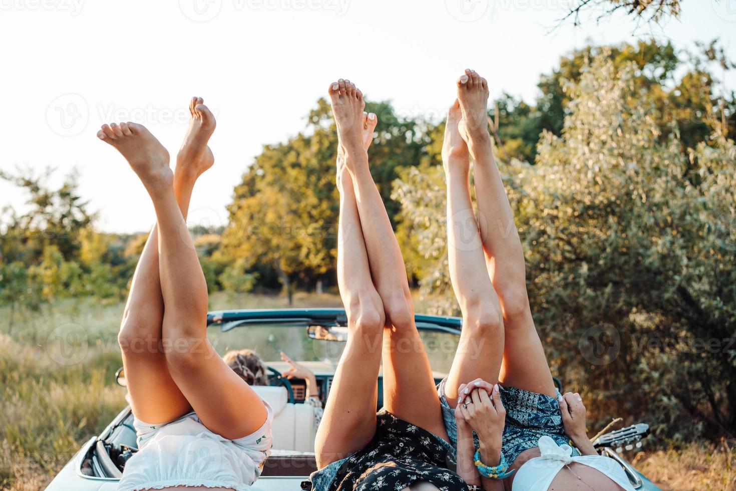 Three girls are lying on the trunk photo